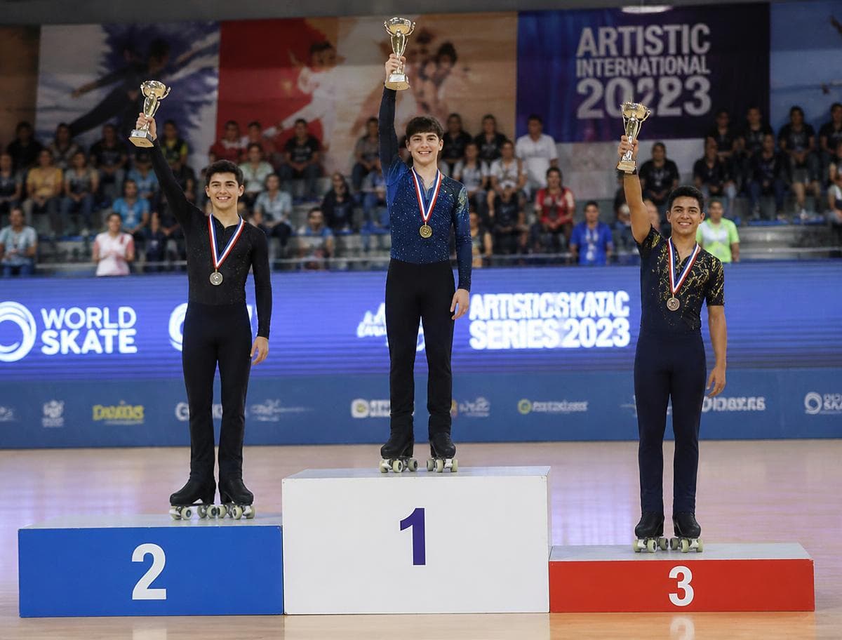 Roller skating championship podium with medal winners raising trophies